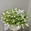 Basket of white tulips with white ribbon