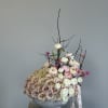Large pastel rose arrangement in a gray pedestal vase