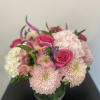 Pink roses and pale chrysanthemums in a glass vase