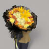 Bouquet of yellow lilies, white roses, and orange accents wrapped in black paper