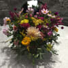 Mixed bouquet with pink, yellow, and cream flowers on a table