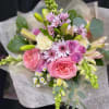 Pink and lavender bouquet with lilies and roses wrapped in paper