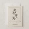A botanical card with a black line drawing of forget-me-nots