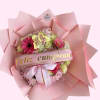 Pink flower bouquet with a birthday ribbon and butterfly decoration