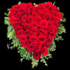 Heart-shaped bouquet of red roses with green foliage