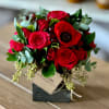 Red rose bouquet with a red anemone in a black box