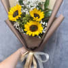 Bouquet of sunflowers and white baby's breath wrapped in brown paper