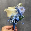 Small bouquet with a cream calla lily and blue flowers held in a hand