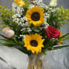 Bouquet of sunflowers and roses in a glass vase