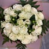 Bouquet of white roses wrapped in pink paper