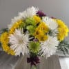 Bouquet of white, yellow, and green chrysanthemums in a glass vase