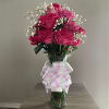 Bouquet of pink roses with baby's breath in a glass vase
