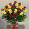 Bouquet of red and yellow roses in a glass vase with a red ribbon