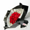 Bouquet of red roses with white baby's breath in black wrapping