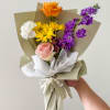 Handheld bouquet with orange, pink, white, yellow, and purple flowers