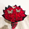 Bouquet of red roses with butterfly picks and black wrapping