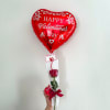 Heart-shaped red Valentine balloon with a single rose in a clear sleeve