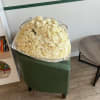 Large bouquet of cream roses wrapped in white paper