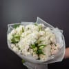 Bouquet of white roses and hydrangeas wrapped in pale paper