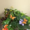 Potted plant arrangement with purple flowers and butterfly decorations
