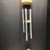 Hanging silver wind chime with orange accents and engraved prayer text