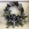 Black-and-white plaid wreath with pinecones and frosted greenery