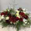 Red and white rose arrangement with a clear glass cross