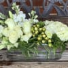 White roses and hydrangeas in a rectangular glass vase