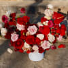 Bouquet of red, pink, and white roses in a white vase