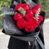 Bouquet of red roses wrapped in black paper