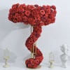 Tall red floral arrangement shaped like a question mark on a gold stand