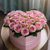 Pink roses arranged in a round pink box