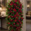 Tall standing floral spray with red roses and gerbera daisies