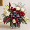 Red and white floral arrangement in a glass vase with a large ribbon and letter A