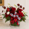 Red and white floral arrangement in a glass vase with a Georgia ribbon