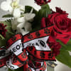 Red roses and white orchids with a football-themed ribbon
