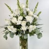 White roses and chrysanthemums in a clear glass vase