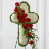 Cross-shaped floral tribute with white flowers and red roses