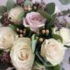 Bouquet of cream and blush roses with eucalyptus and small purple filler flowers