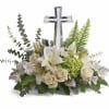 White floral arrangement with a silver cross centerpiece