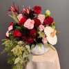 A sophisticated mix of deep red and blush blooms, artfully arranged in