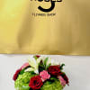 Cute small arrangement with happy colors to bright up someone's day.