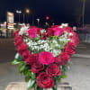 Bouquet of red roses and white baby's breath in a white vase