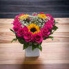 Pink roses and sunflowers in a white square vase