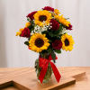 Bouquet of red roses and yellow sunflowers in a glass vase with a red ribbon