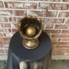 Gold baseball glove sculpture with a ball inside