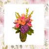 Pink and orange flowers arranged in a glass vase