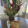 Tropical bouquet in a glass vase with a gift tag