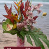 Tropical bouquet in a pink vase with orchids and red-orange heliconia