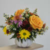 Mixed bouquet of roses and chrysanthemums in a white pumpkin vase